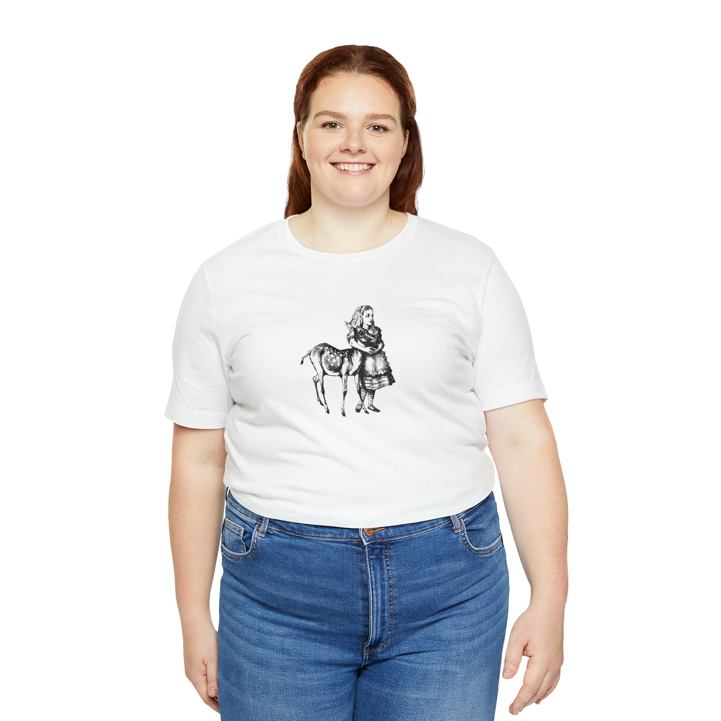 A smiling plus sized woman wearing a white t-shirt with an illustration of Alice in Wonderland and a baby deer printed in black.